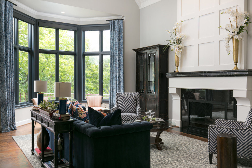 Photo of a large open concept living room in Kansas City with grey walls, medium hardwood floors, a standard fireplace, a stone fireplace surround and no tv.
