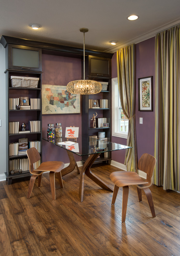 This is an example of a transitional dining room in Columbus with purple walls.