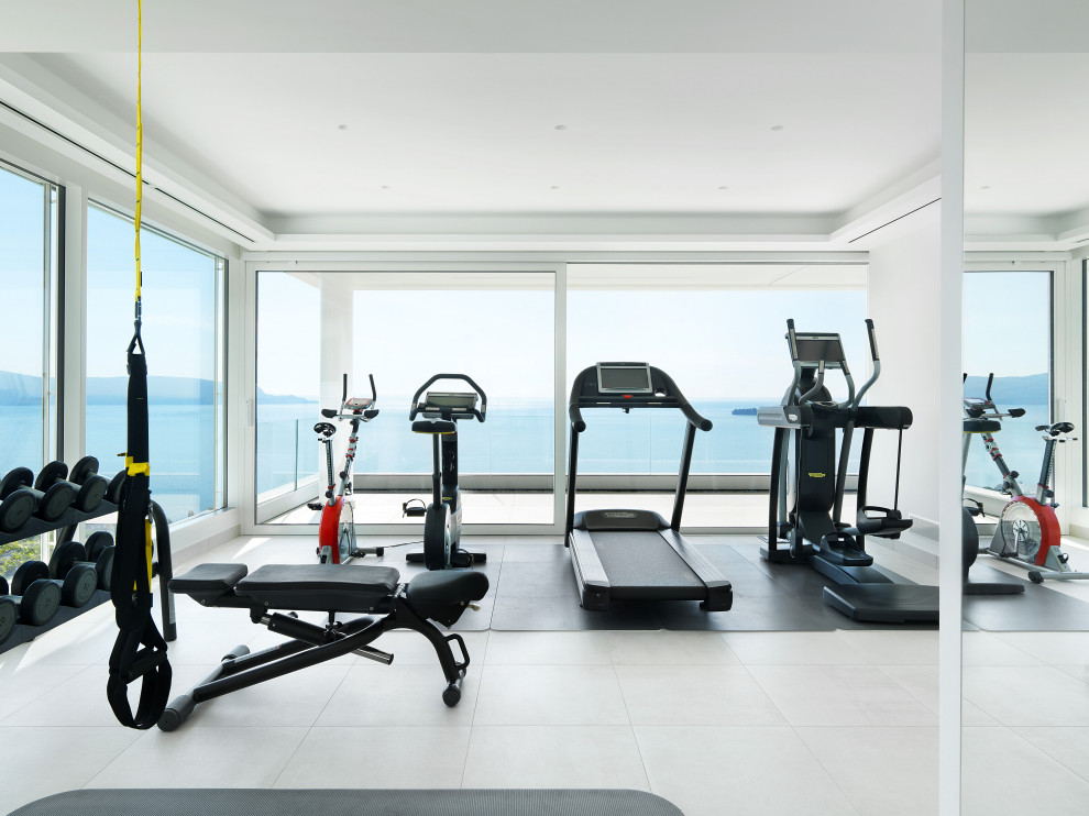 Large contemporary multipurpose gym in Milan with white walls, porcelain floors and white floor.