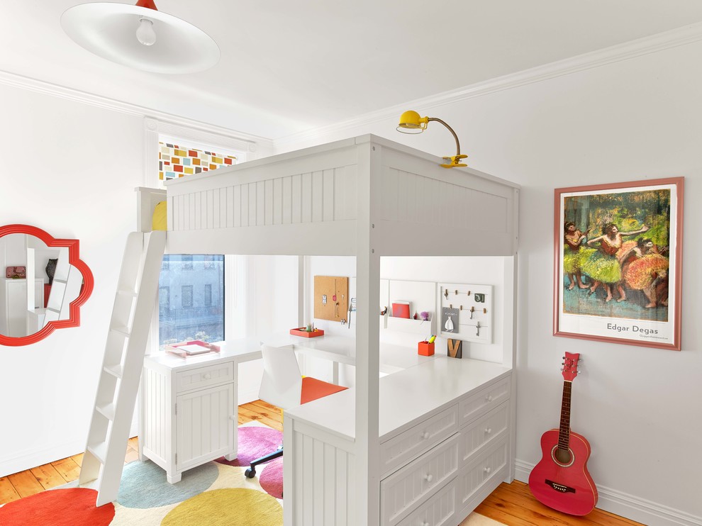 Example of a bedroom transitional loft-style and girl medium tone wood floor kids' bedroom design in New York with white walls
