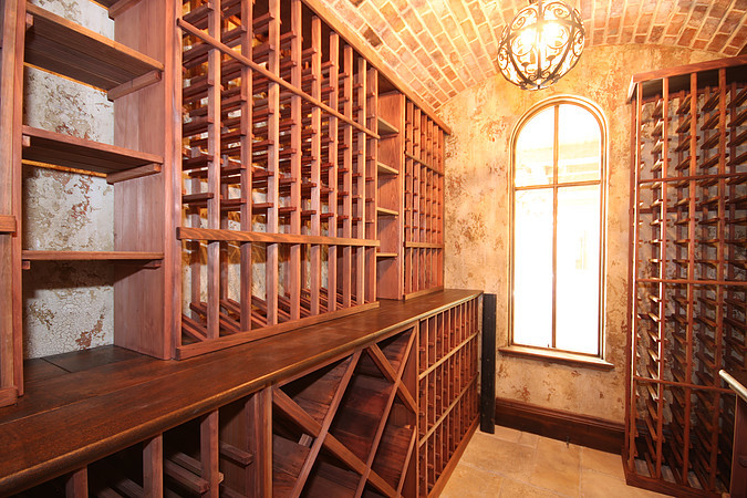 Inspiration for a rustic wine cellar remodel in Denver with storage racks