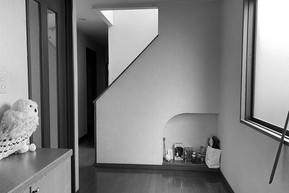 Esempio di un piccolo corridoio nordico con pareti bianche, pavimento in legno verniciato, una porta singola, una porta nera, pavimento marrone, soffitto in carta da parati e carta da parati