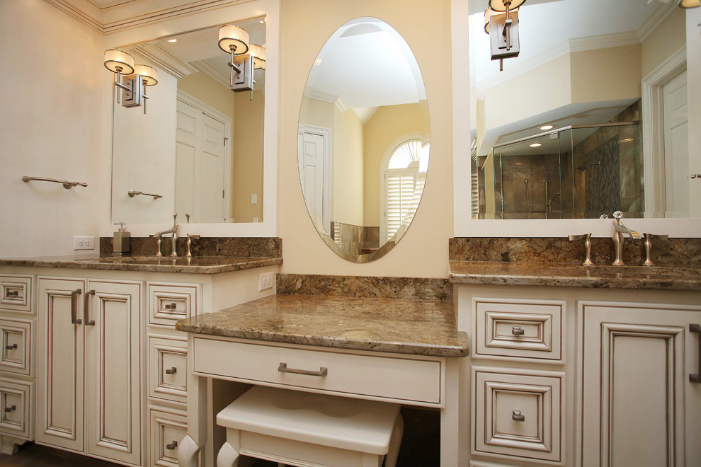 Large traditional master bathroom in Charlotte with an undermount sink, recessed-panel cabinets, medium wood cabinets, granite benchtops, a corner shower, a one-piece toilet, beige tile, beige walls and porcelain floors.