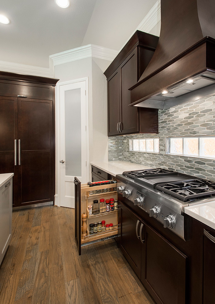 Inspiration for a mid-sized transitional l-shaped open plan kitchen in DC Metro with an undermount sink, recessed-panel cabinets, dark wood cabinets, granite benchtops, beige splashback, ceramic splashback, stainless steel appliances, medium hardwood floors, with island, brown floor and beige benchtop.