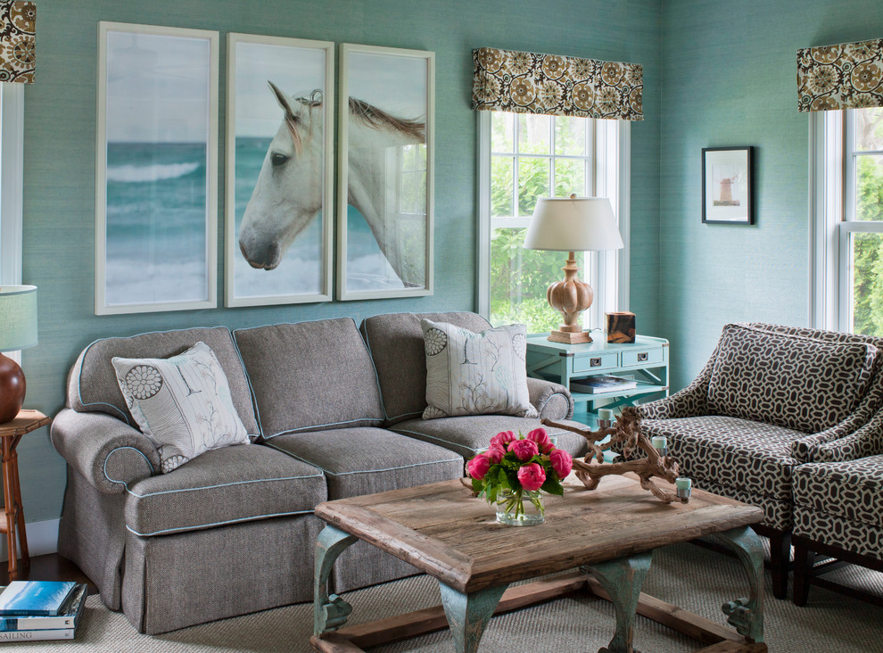 Beach style living room in New York with blue walls, dark hardwood floors and brown floor.