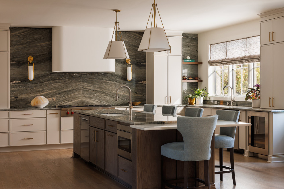 Inspiration for a large transitional u-shaped medium tone wood floor open concept kitchen remodel in New York with an undermount sink, shaker cabinets, beige cabinets, quartzite countertops, green backsplash, stone slab backsplash, stainless steel appliances, an island and green countertops