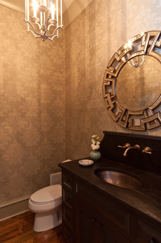 Photo of a transitional powder room in Other with an undermount sink and dark wood cabinets.
