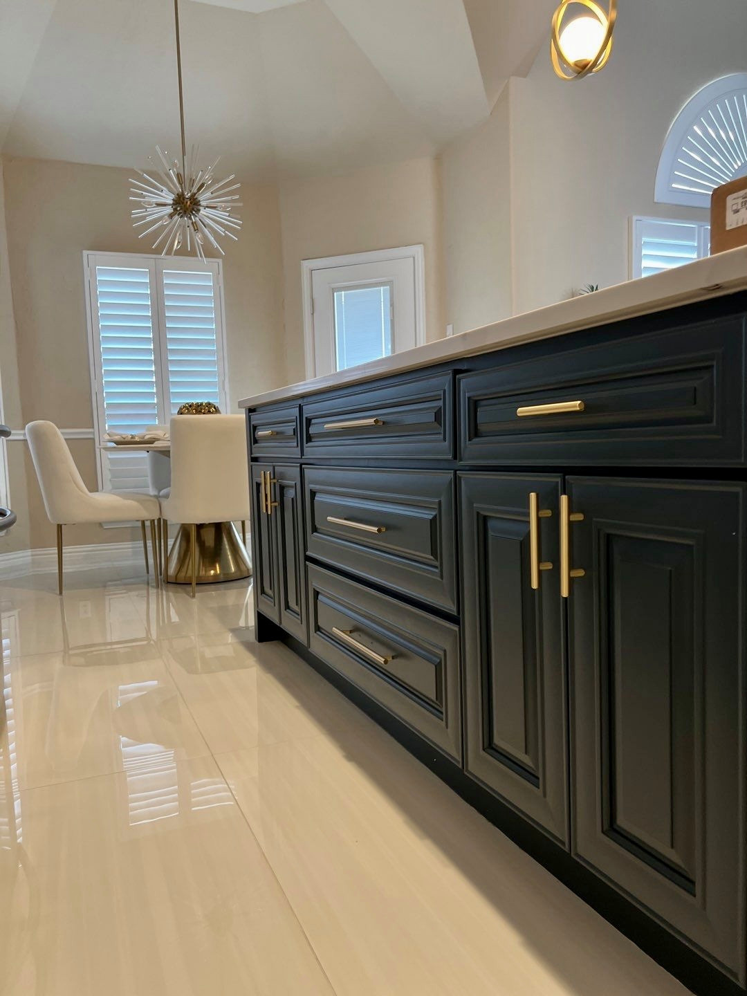 Transitional galley porcelain tile and vaulted ceiling eat-in kitchen photo in Dallas with an undermount sink, raised-panel cabinets, quartz countertops, white backsplash, porcelain backsplash, stainl