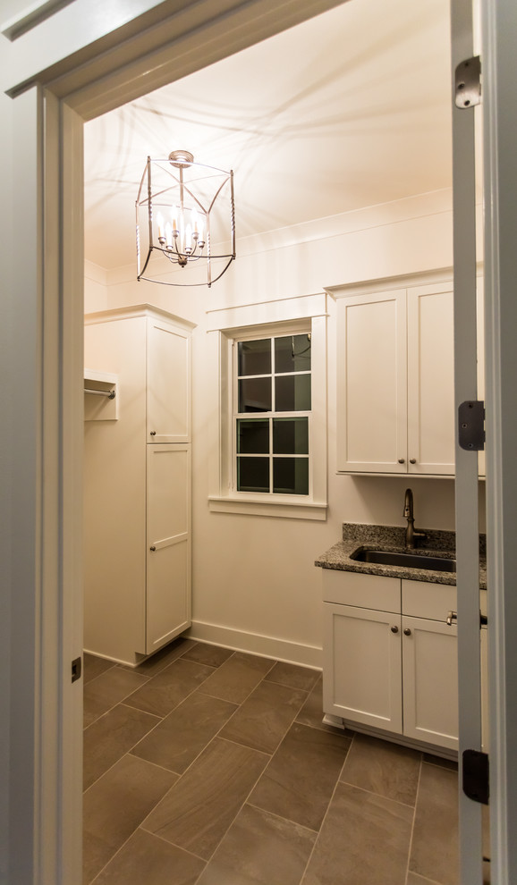 This is an example of a transitional dedicated laundry room in Other with an undermount sink, shaker cabinets, white cabinets and white walls.