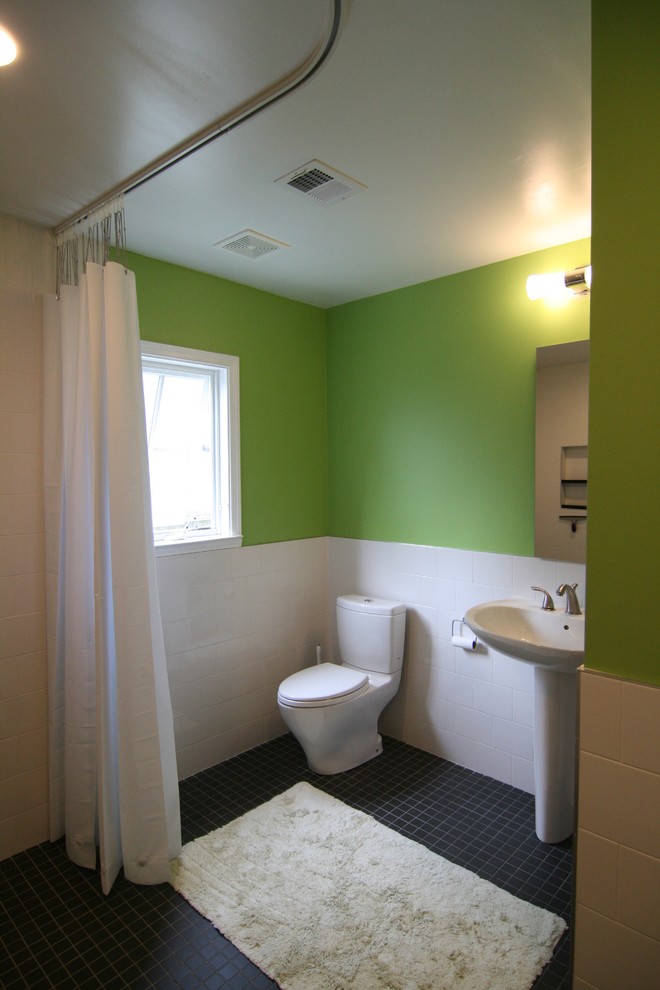 Small modern 3/4 bathroom in DC Metro with a pedestal sink, an open shower, a two-piece toilet, white tile, ceramic tile, green walls and ceramic floors.