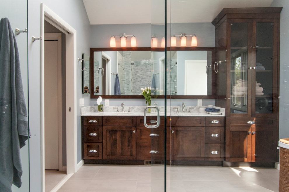 This is an example of a large transitional master bathroom in Philadelphia with an undermount sink, shaker cabinets, dark wood cabinets, granite benchtops, a double shower, white tile, stone tile, blue walls and porcelain floors.