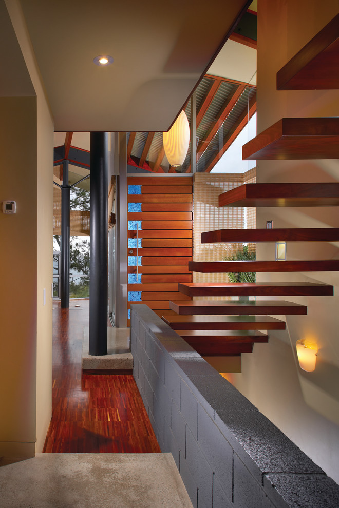 Inspiration for a contemporary hallway in Orange County with beige walls and red floor.