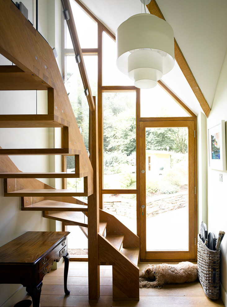 Contemporary wood l-shaped staircase in Surrey with open risers and wood railing.