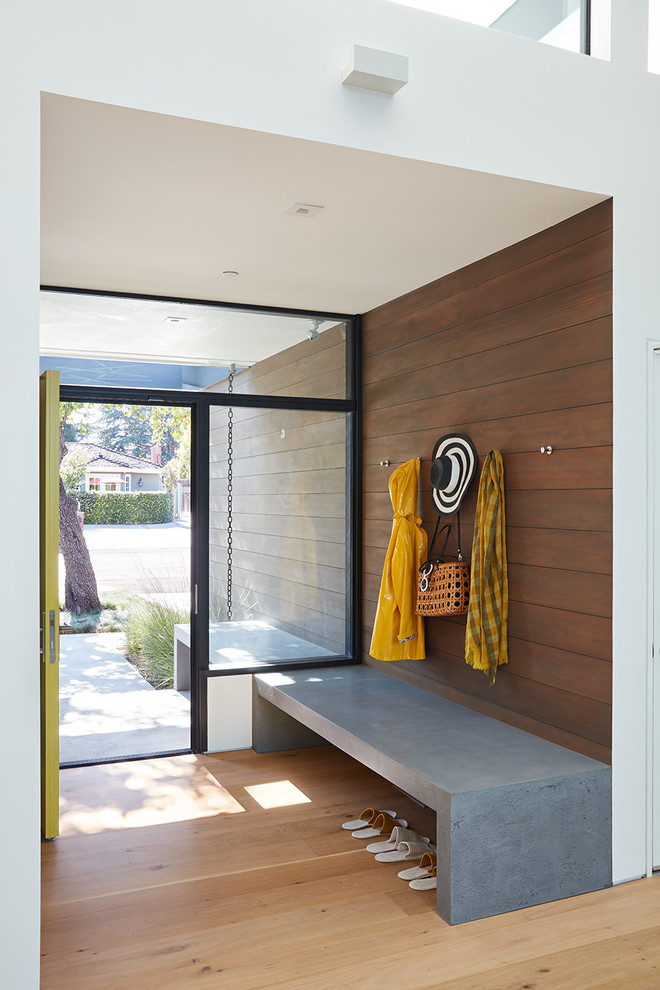 Inspiration for a midcentury entryway in San Francisco with brown walls and light hardwood floors.