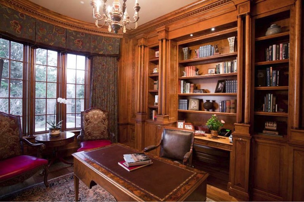 Photo of a traditional home office in Nashville with dark hardwood floors and a freestanding desk.