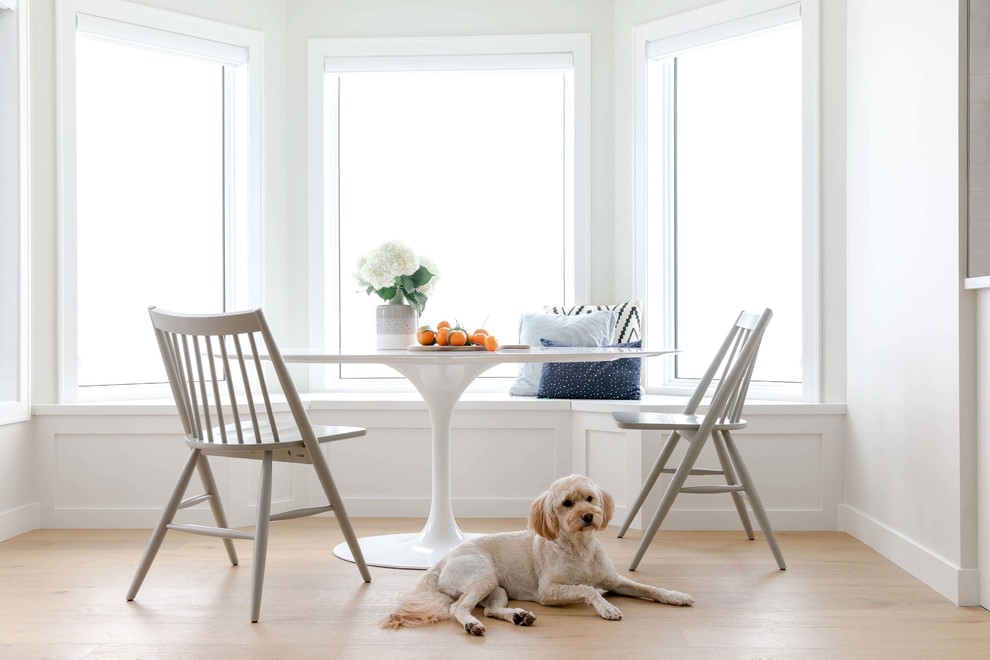 Example of a large transitional u-shaped medium tone wood floor and brown floor kitchen/dining room combo design in Calgary with an undermount sink, shaker cabinets, white cabinets, quartzite countertops, white backsplash, subway tile backsplash, stainless steel appliances, an island and white countertops