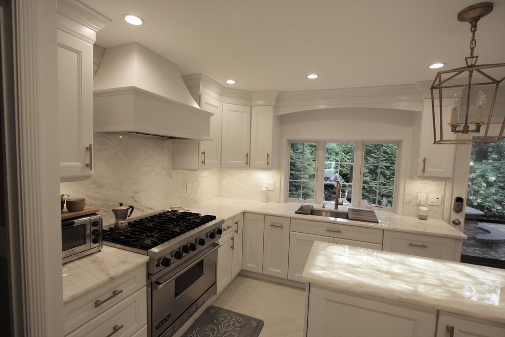 Inspiration for a mid-sized transitional galley eat-in kitchen in New York with recessed-panel cabinets, white cabinets, onyx benchtops, white splashback, marble splashback, stainless steel appliances, ceramic floors, with island, beige floor and white benchtop.