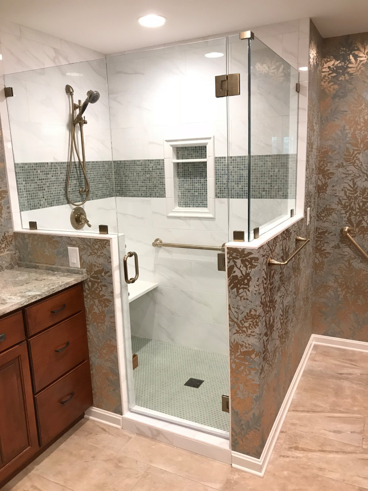 Example of a mid-sized classic master white tile and ceramic tile ceramic tile, multicolored floor, double-sink and wallpaper bathroom design in Louisville with raised-panel cabinets, medium tone wood cabinets, a two-piece toilet, multicolored walls, an undermount sink, quartz countertops, a hinged shower door, multicolored countertops and a built-in vanity