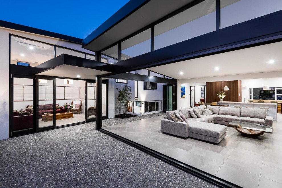 Design ideas for an expansive modern open concept living room in Perth with white walls, porcelain floors, a wall-mounted tv and grey floor.