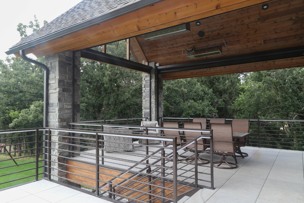 Large transitional backyard deck photo with a roof extension