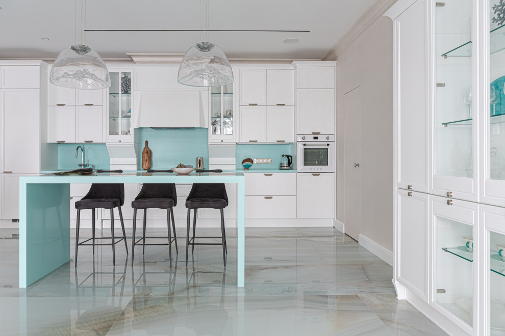 Design ideas for a large contemporary single-wall open plan kitchen in Other with with island, recessed-panel cabinets, white cabinets, white appliances and turquoise benchtop.