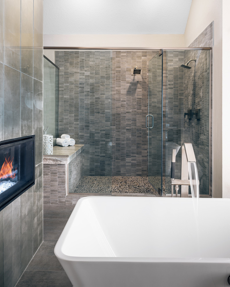 Large modern master bathroom in Other with flat-panel cabinets, distressed cabinets, a freestanding tub, a double shower, a one-piece toilet, white tile, ceramic tile, beige walls, ceramic floors, an undermount sink, granite benchtops, grey floor and a hinged shower door.