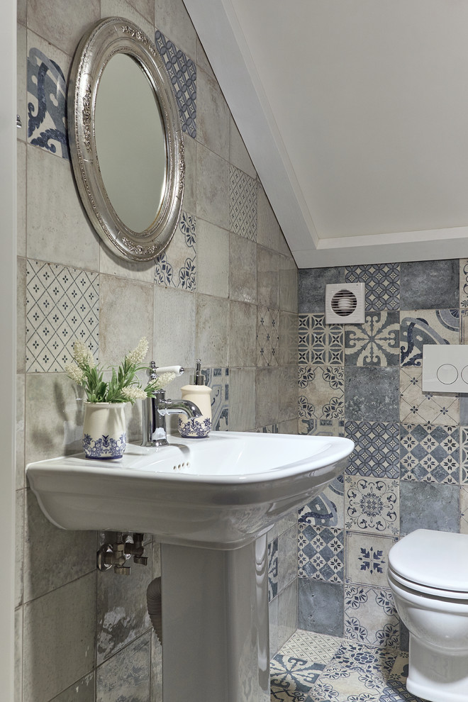 Inspiration for a small traditional powder room in Other with gray tile, blue tile, a pedestal sink, a one-piece toilet and multi-coloured floor.