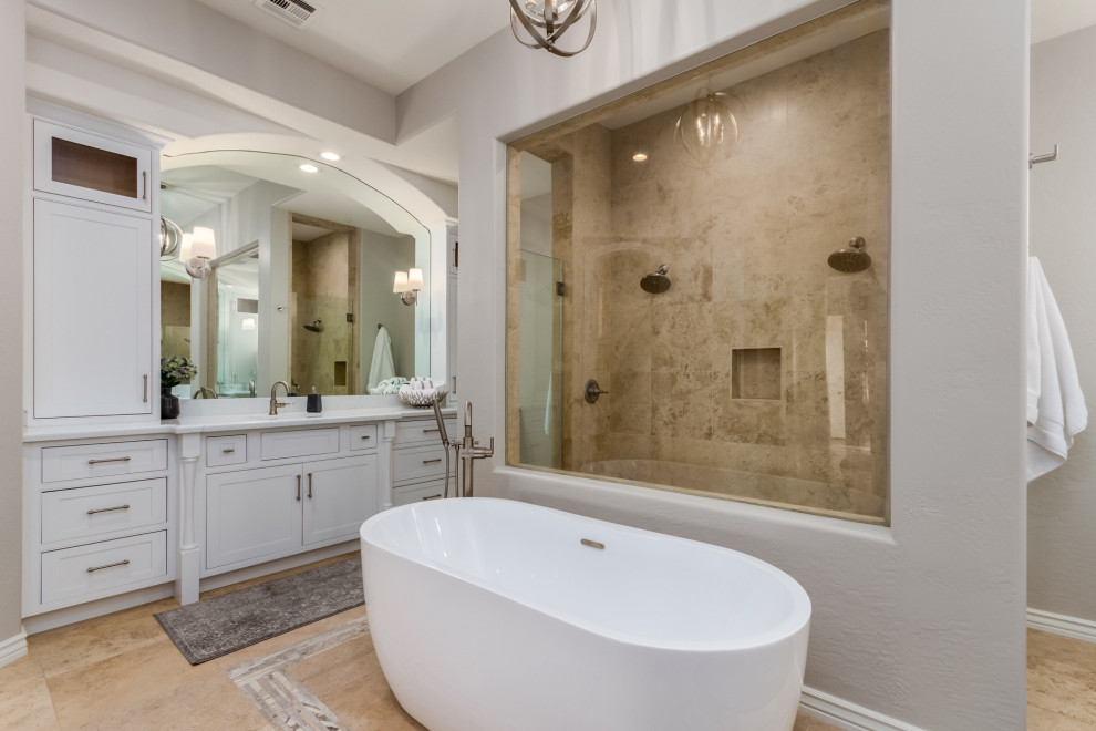 Freestanding bathtub - large transitional master travertine floor and beige floor freestanding bathtub idea in Phoenix with beaded inset cabinets, white cabinets, quartz countertops and white countertops