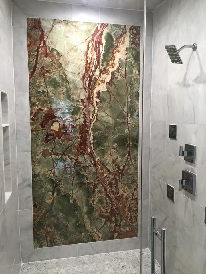 Freestanding bathtub - mid-sized transitional master ceramic tile freestanding bathtub idea in Dallas with recessed-panel cabinets, black cabinets, white walls, an undermount sink and marble countertops