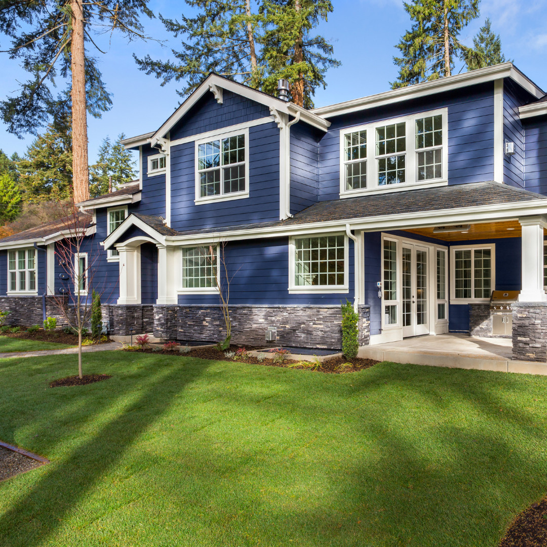 new luxury home builder blue house with brick and new windows and landscaping