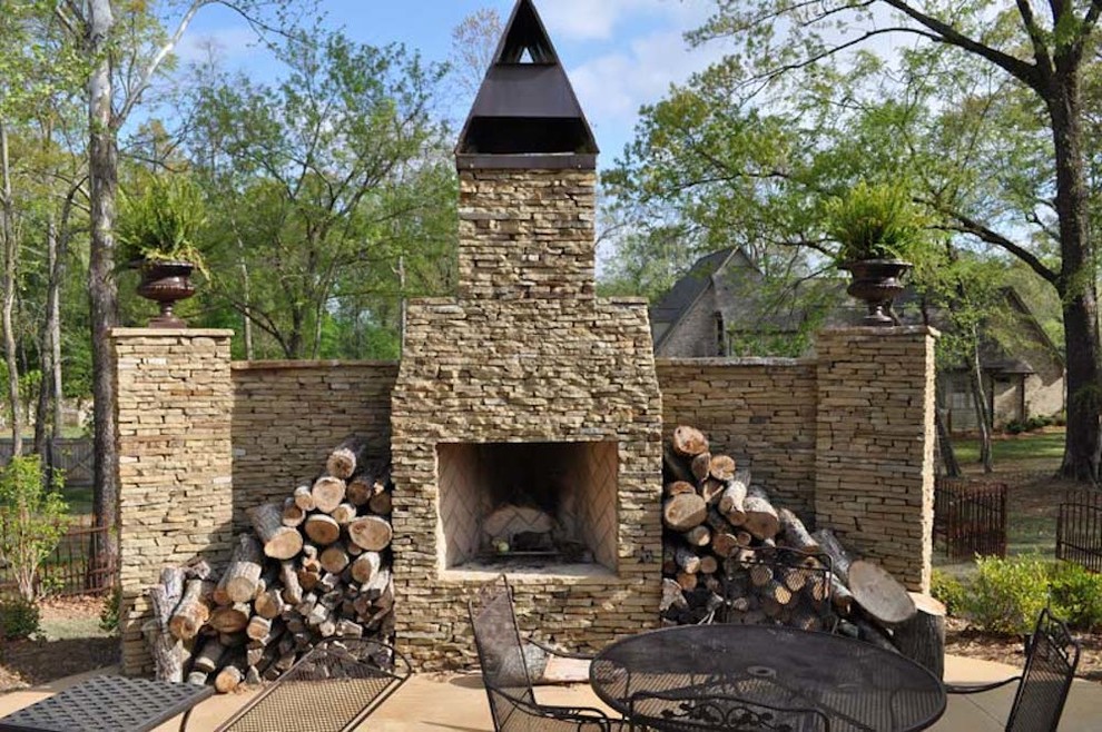 Large traditional side yard patio in Jackson with a fire feature, brick pavers and no cover.