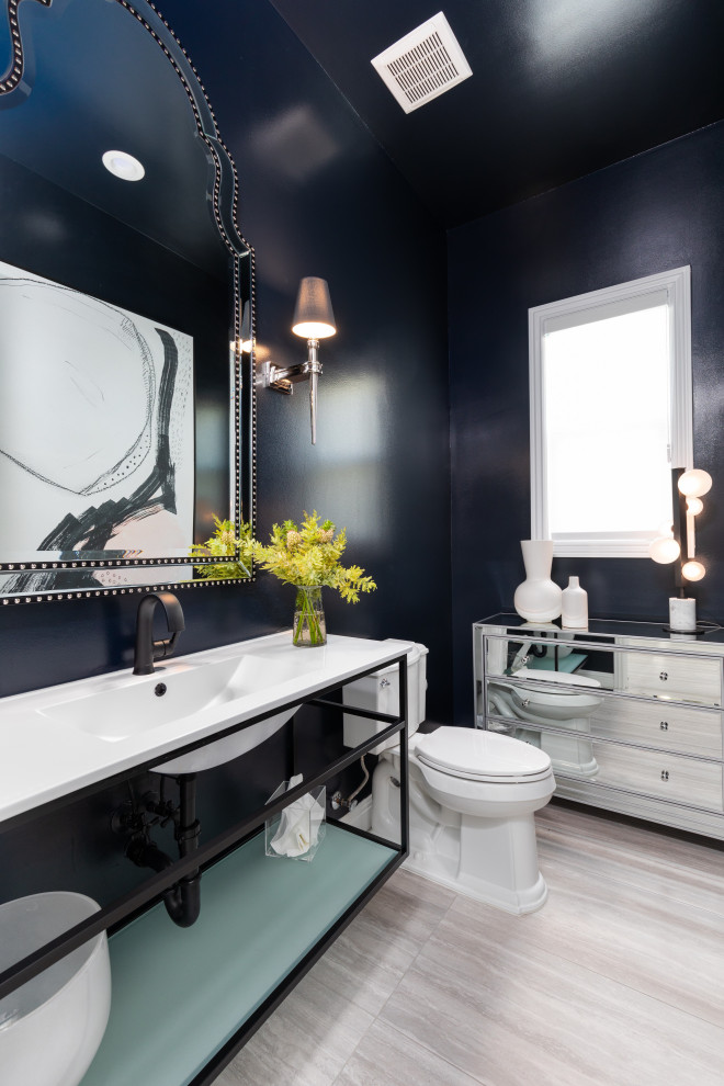Inspiration for a transitional multicolored floor and vaulted ceiling powder room remodel in Other with open cabinets, black cabinets, a two-piece toilet, black walls, an integrated sink, white countertops and a built-in vanity