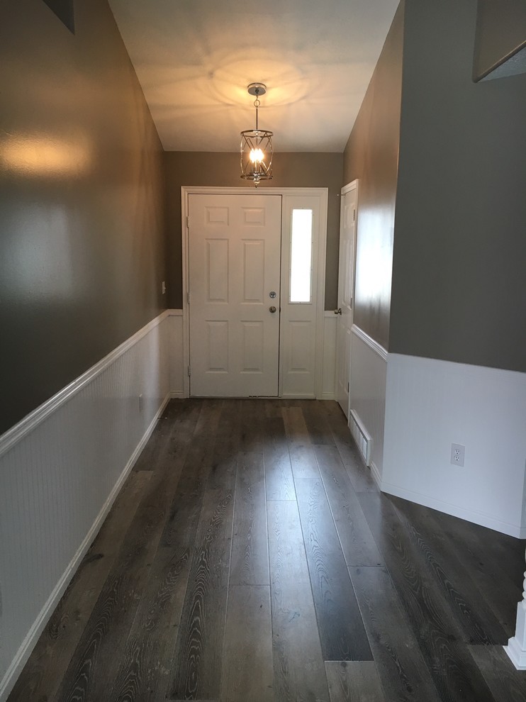 Photo of a mid-sized contemporary entry hall in Other with grey walls, a single front door and a white front door.