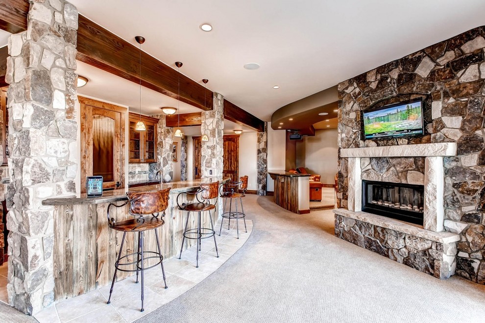 Large mountain style home bar photo in Denver