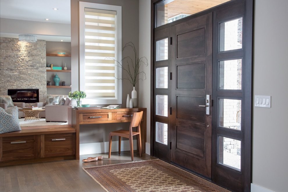 Inspiration for a mid-sized transitional vinyl floor front door remodel in Calgary with gray walls and a dark wood front door