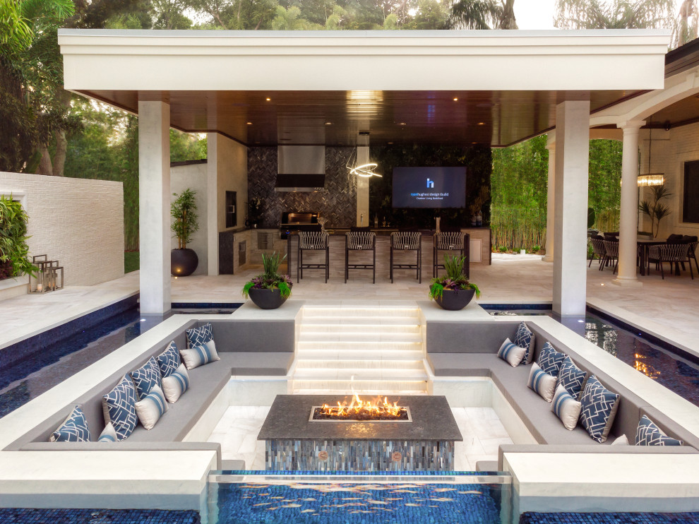 This is an example of a large contemporary backyard patio in Tampa with tile.