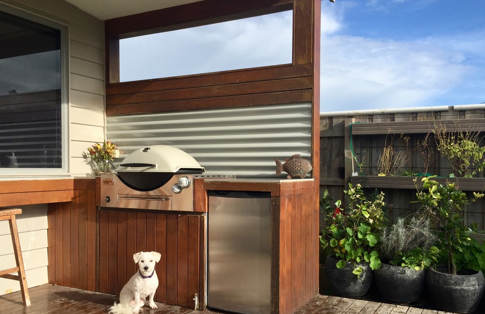 Inspiration for a mid-sized beach style backyard deck in Melbourne with a roof extension.
