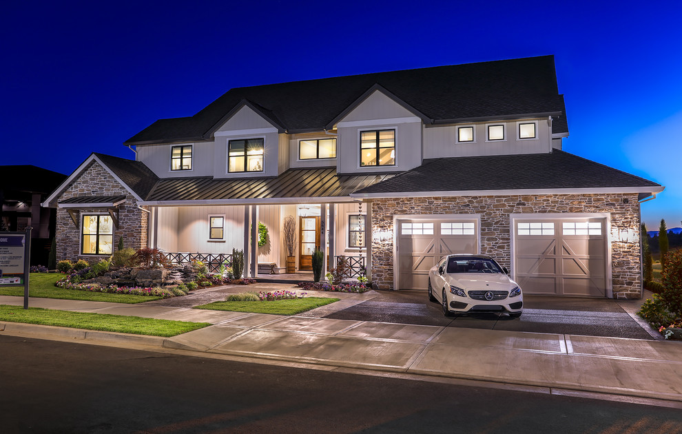 Example of a huge country beige two-story mixed siding house exterior design in Portland with a shed roof and a mixed material roof