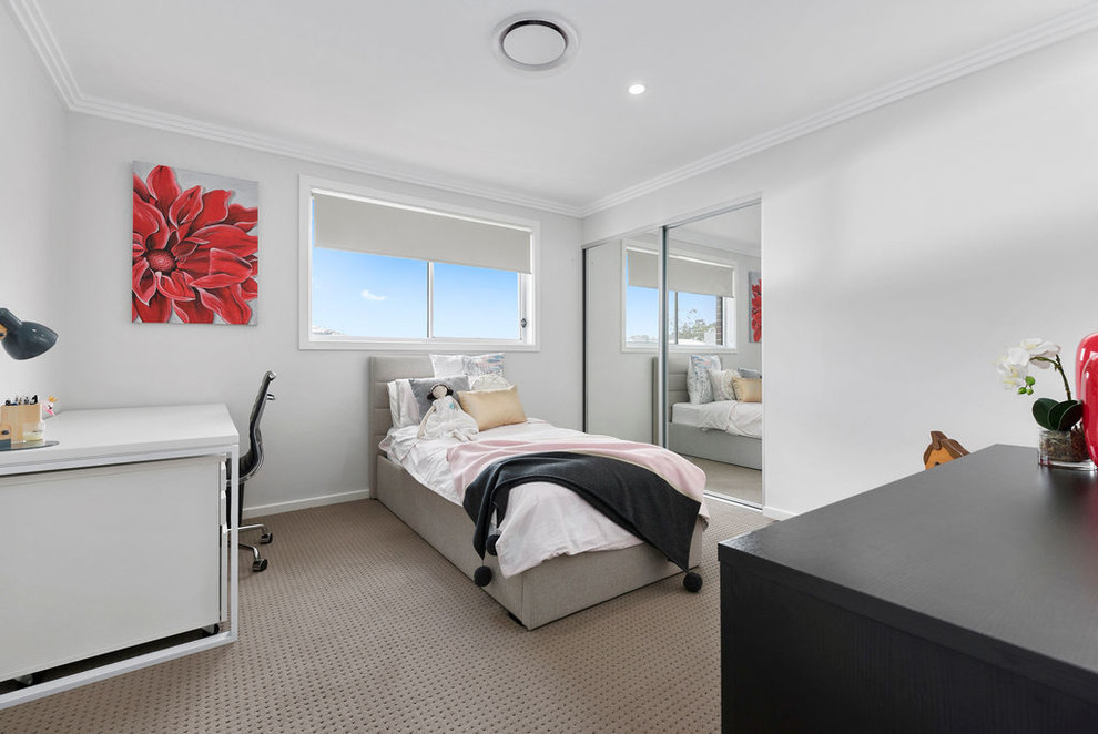 This is an example of a contemporary bedroom in Sydney.