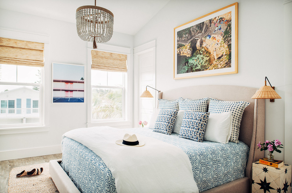 Mid-sized beach style master bedroom in Nashville with white walls, no fireplace and brown floor.