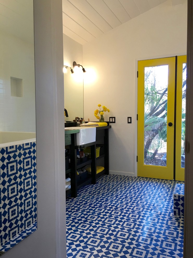 This is an example of a mid-sized eclectic master bathroom in Los Angeles with open cabinets, black cabinets, blue tile, white tile, mosaic tile, wood benchtops, a japanese tub, white walls, mosaic tile floors and a drop-in sink.