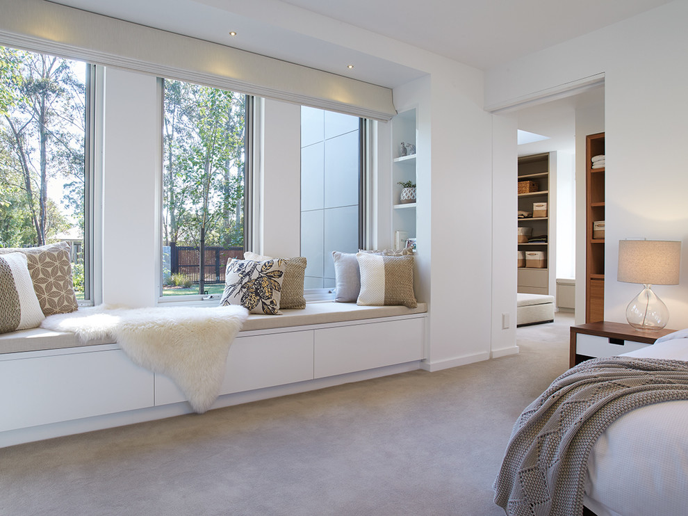 This is an example of a large contemporary master bedroom in Melbourne with white walls and carpet.