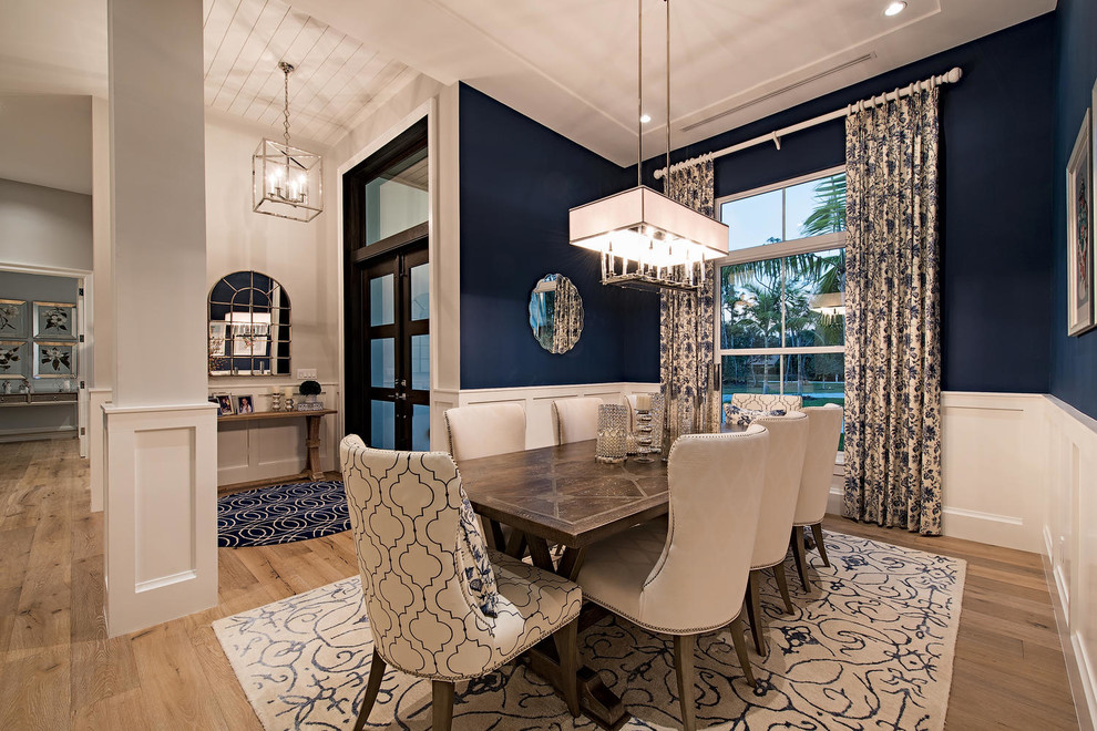 Photo of a contemporary kitchen/dining combo in Miami with blue walls and light hardwood floors.