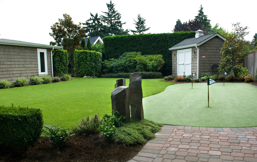 This is an example of a mid-sized traditional full sun backyard concrete paver landscaping in Seattle for summer.