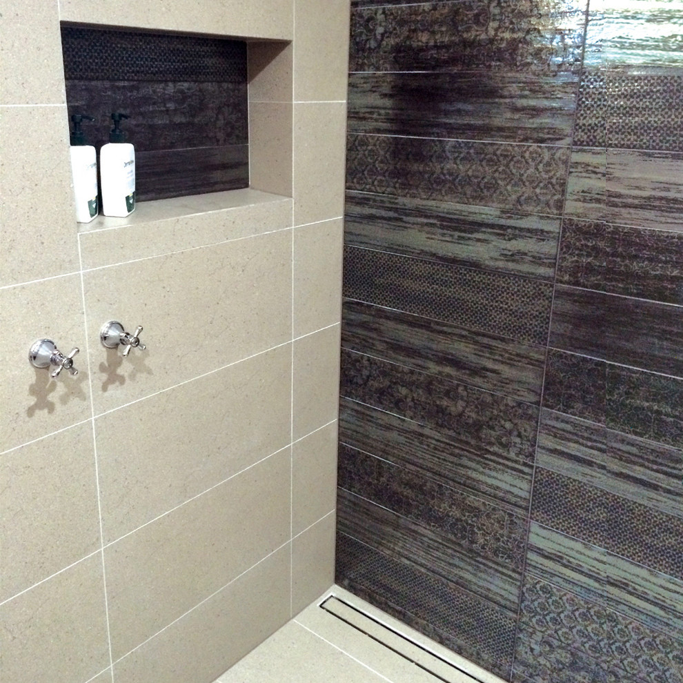 Photo of a small tropical master bathroom in Perth with open cabinets, dark wood cabinets, an open shower, gray tile, porcelain tile, porcelain floors, a vessel sink and wood benchtops.
