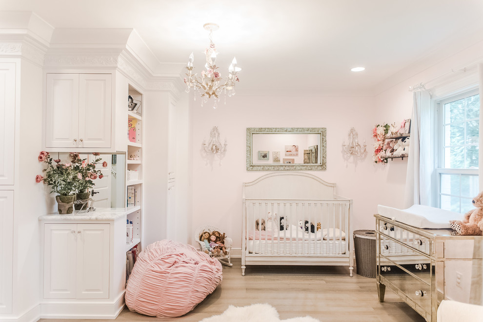 Photo of a large traditional nursery for girls in Indianapolis with medium hardwood floors.
