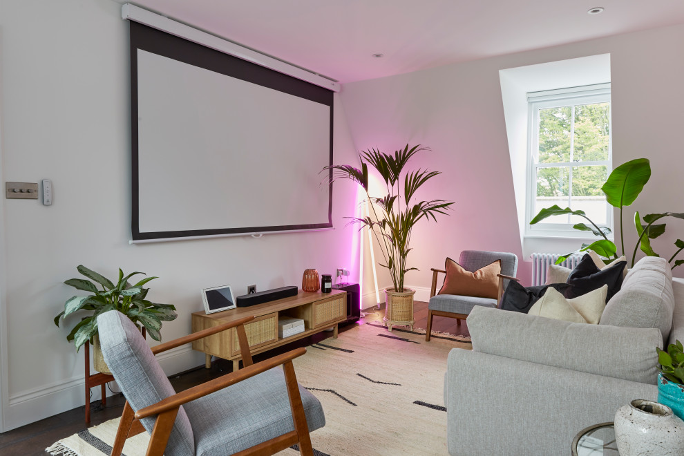 Photo of a small classic open plan home cinema in London with white walls, dark hardwood flooring, a projector screen, brown floors and feature lighting.