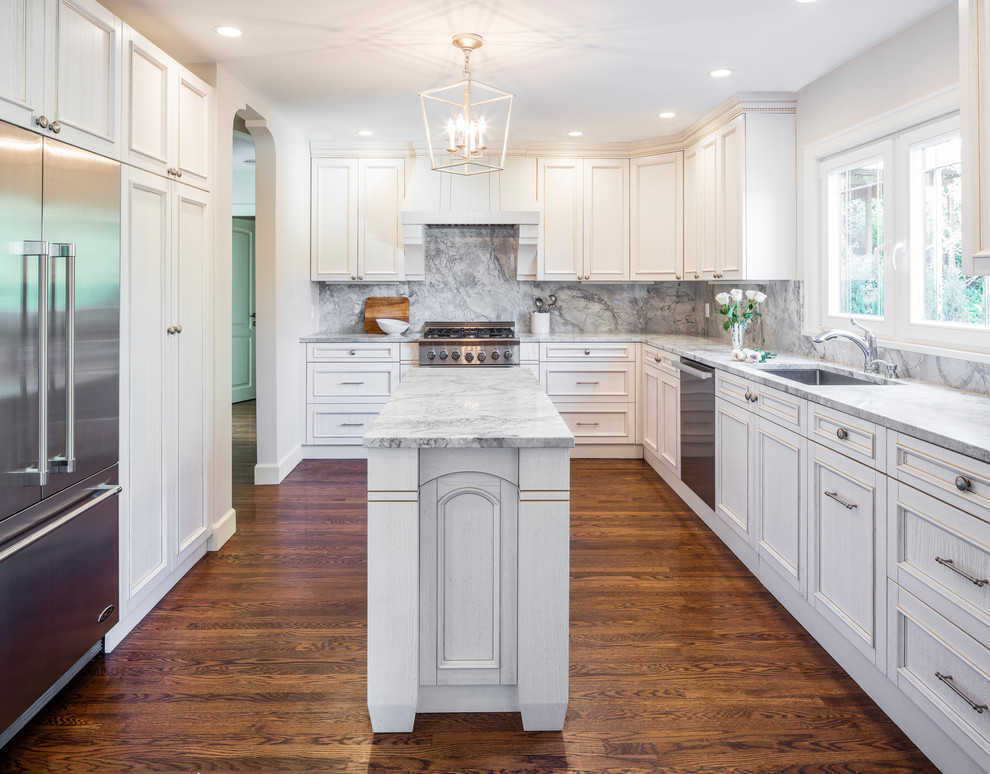 Inspiration for a mid-sized traditional u-shaped separate kitchen in Seattle with an undermount sink, beaded inset cabinets, light wood cabinets, quartzite benchtops, grey splashback, stone slab splashback, stainless steel appliances, dark hardwood floors, with island, brown floor and grey benchtop.