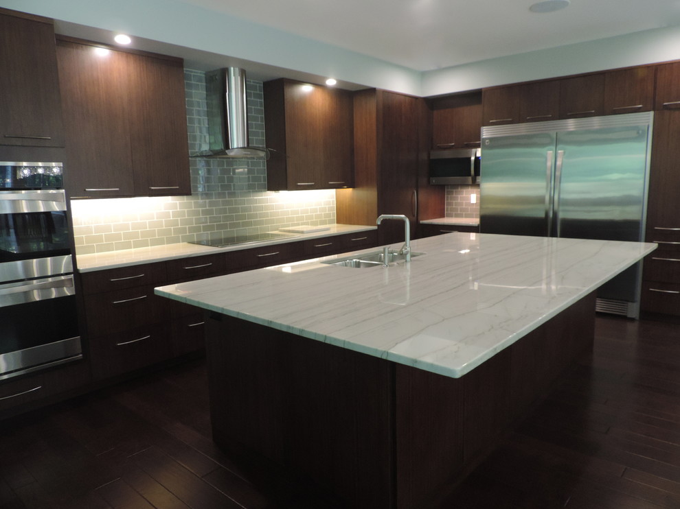 Inspiration for a mid-sized contemporary l-shaped open plan kitchen in Grand Rapids with a double-bowl sink, flat-panel cabinets, dark wood cabinets, quartzite benchtops, grey splashback, glass tile splashback, stainless steel appliances, dark hardwood floors and with island.