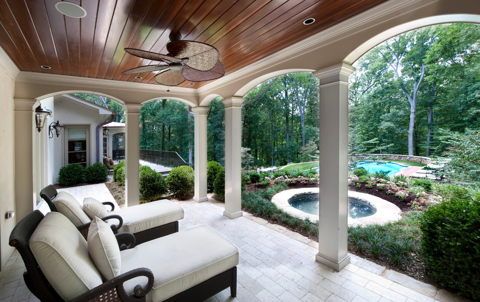 Inspiration for a mid-sized mediterranean backyard patio in DC Metro with brick pavers and a roof extension.